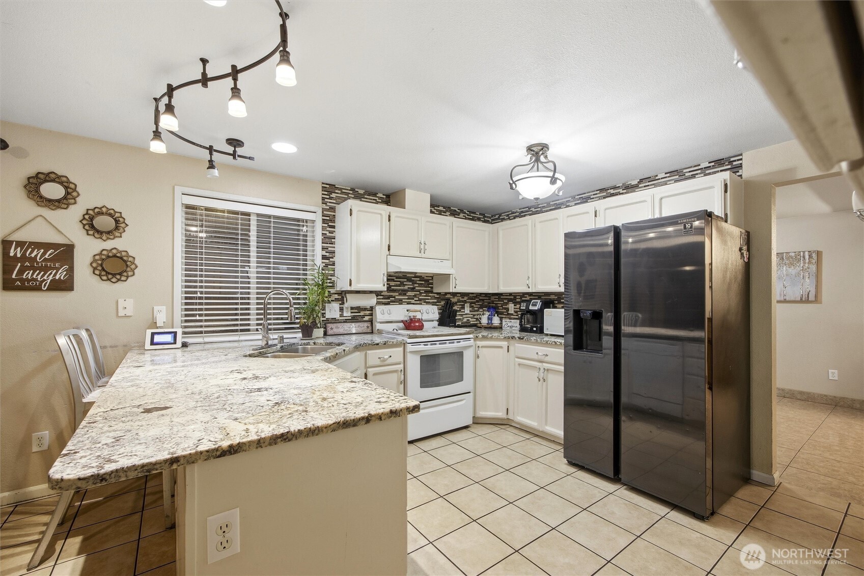 5008 Polo Lane Pasco, WA 99301 - Photo 14 of 26 a kitchen with stainless steel appliances granite countertop a sink refrigerator and cabinets