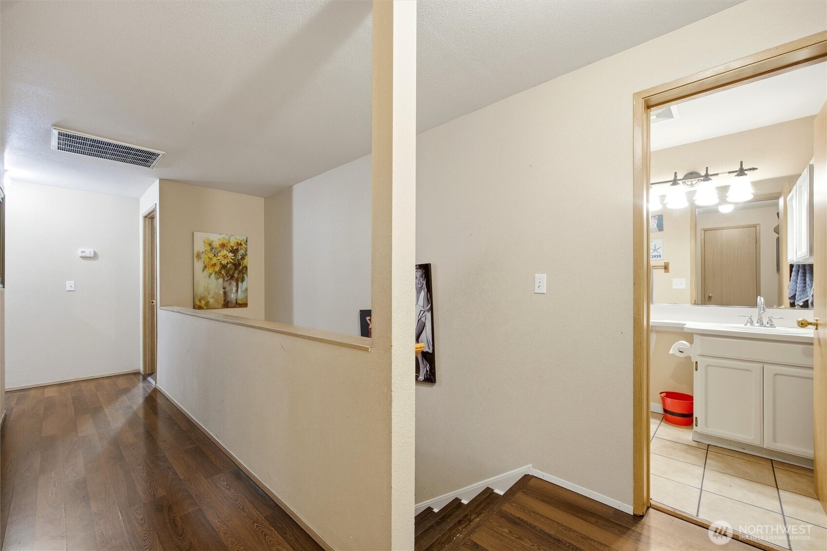 5008 Polo Lane Pasco, WA 99301 - Photo 25 of 26 a view of a hallway with bathroom and wooden floor