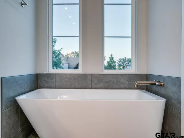 a bathroom with a bathtub and window