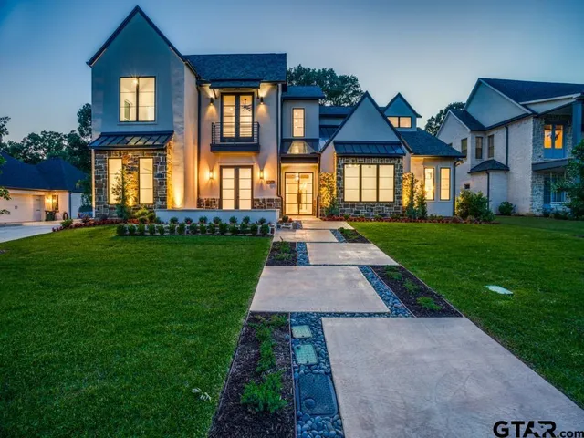 a front view of a brick house with a yard