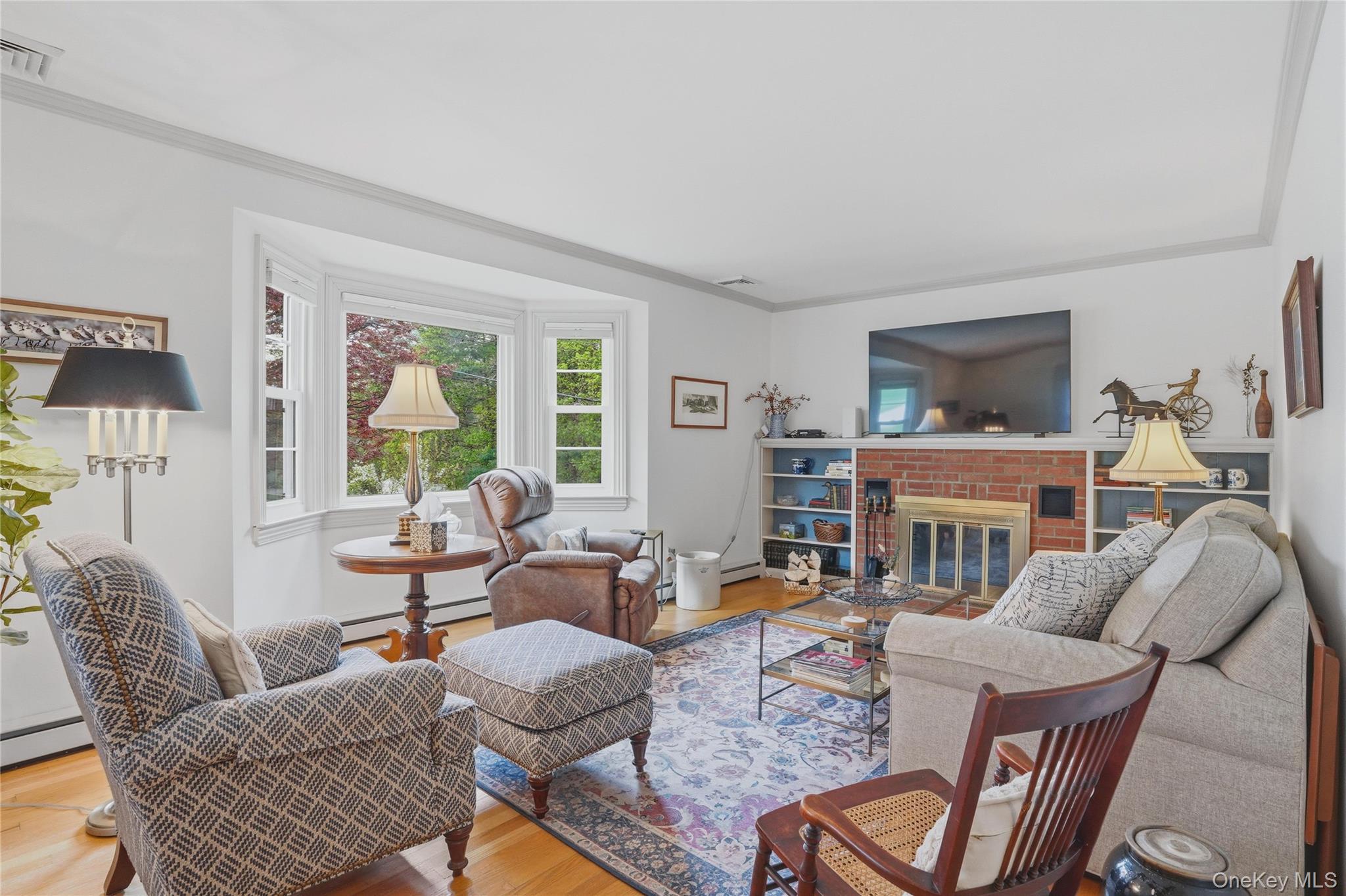 6 Willow Lane Fishkill, NY 12524 - Photo 11 of 33 a living room with furniture a fireplace and a large window