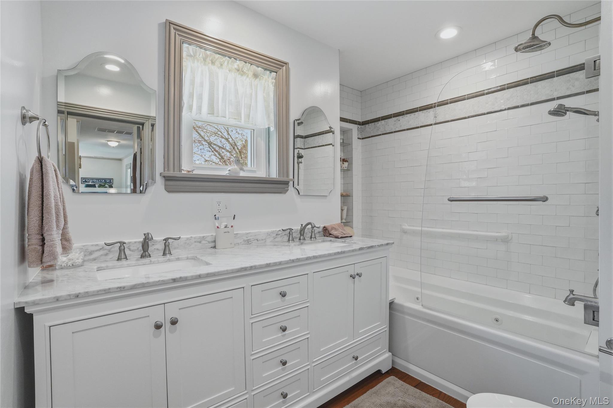6 Willow Lane Fishkill, NY 12524 - Photo 16 of 33 a bathroom with a granite countertop sink a mirror a bathtub and shower