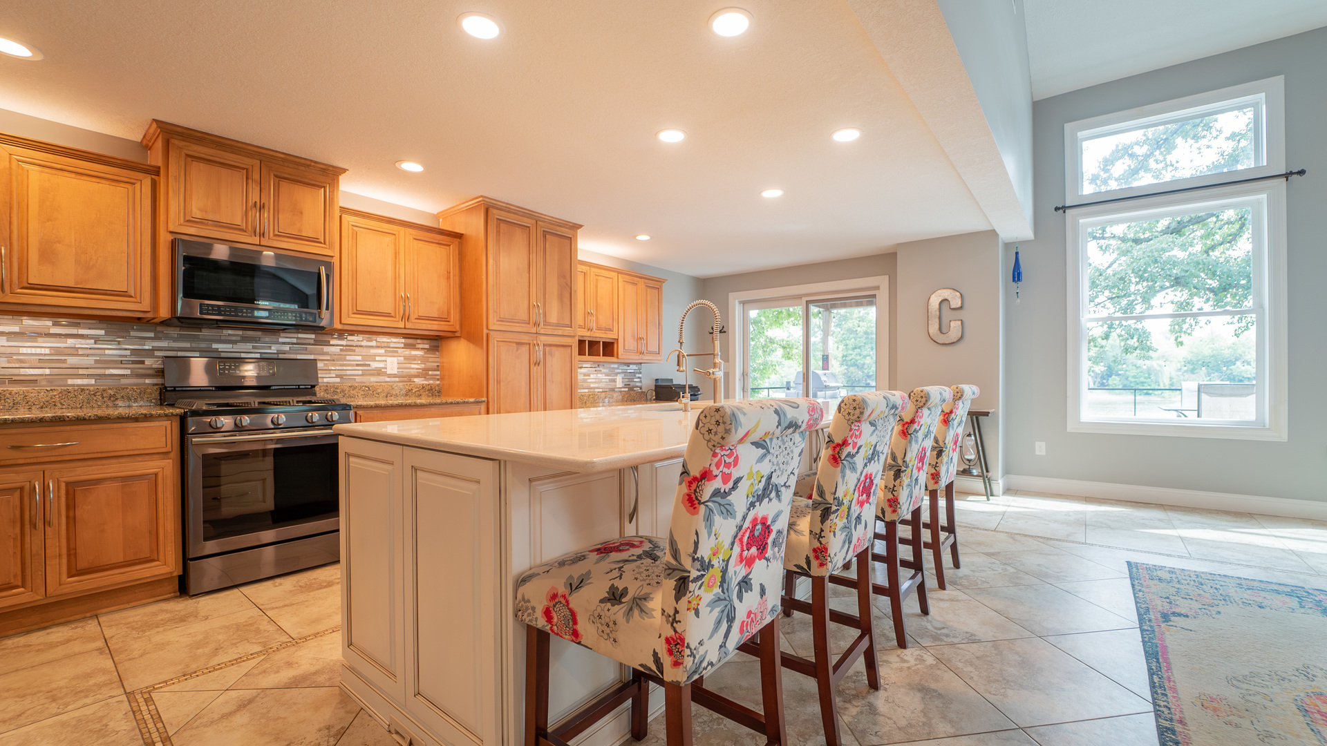 2611 2560 River Road Kankakee, IL 60901 - Photo 28 of 53 a kitchen with stainless steel appliances kitchen island granite countertop a stove top oven a sink a dining table and chairs