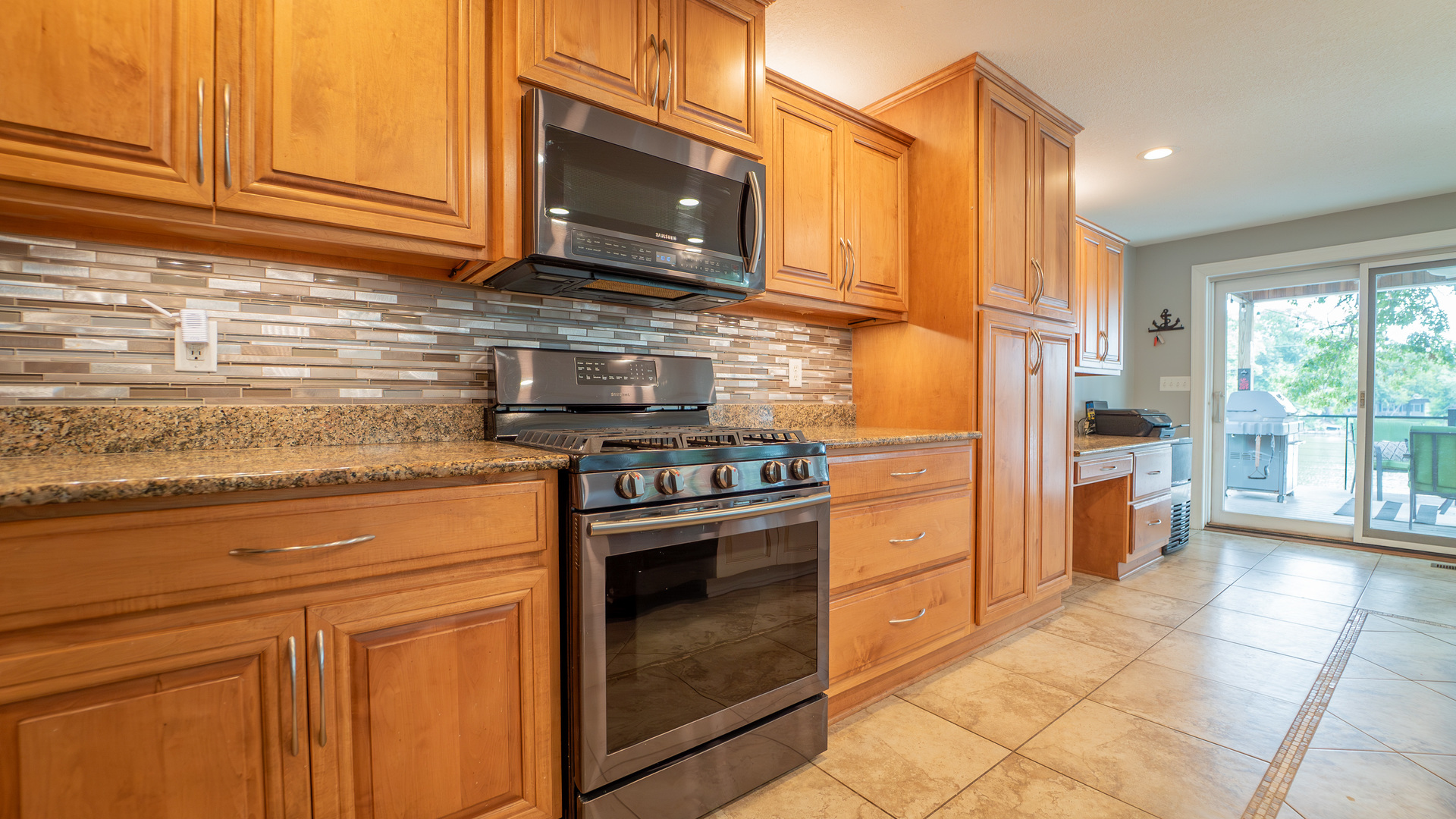 2611 2560 River Road Kankakee, IL 60901 - Photo 29 of 53 a kitchen with stainless steel appliances granite countertop a stove a sink and a microwave