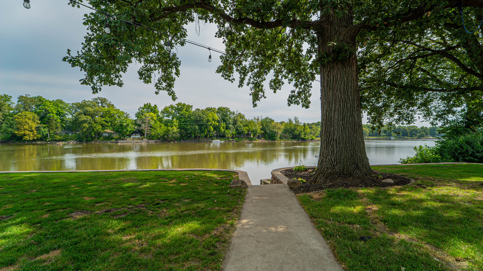 2611 2560 River Road Kankakee, IL 60901 - Photo 6 of 53 a view of a lake next to a yard with large trees