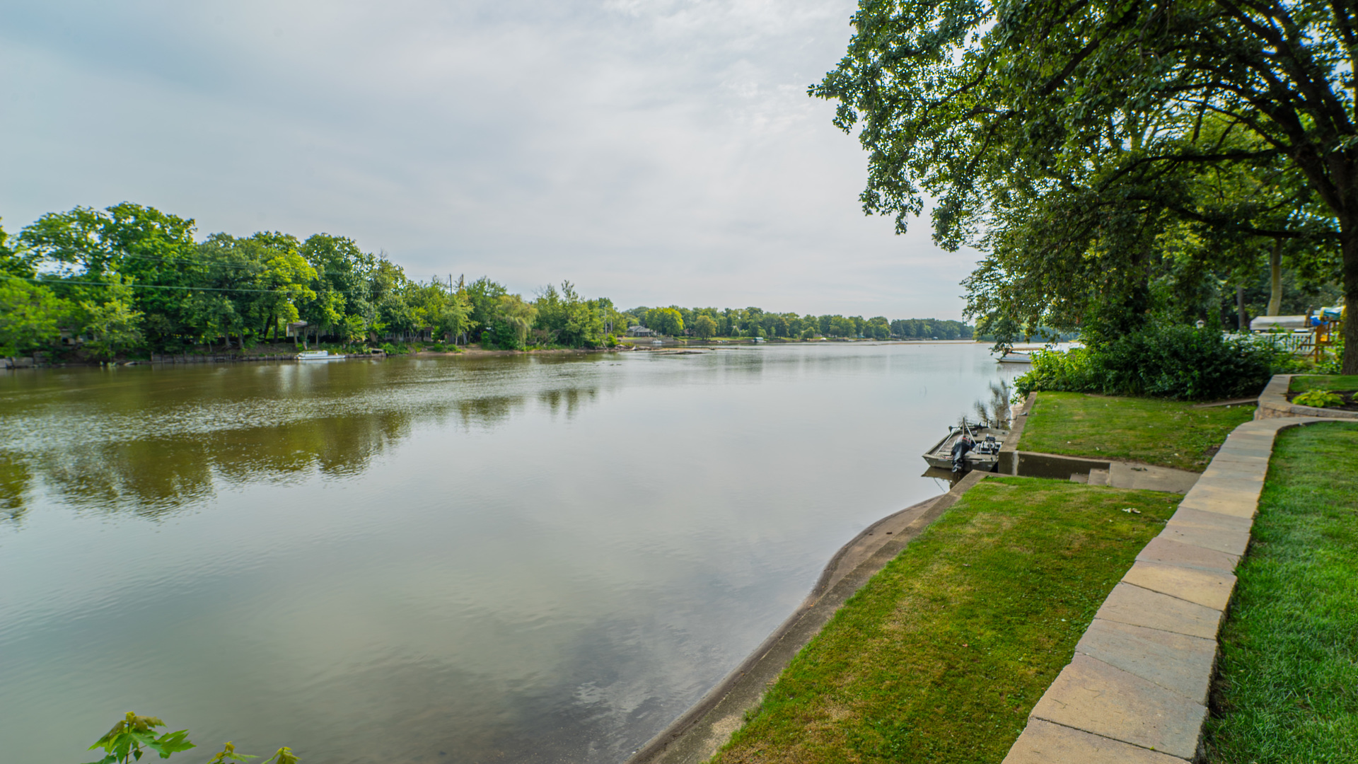 2611 2560 River Road Kankakee, IL 60901 - Photo 7 of 53 a view of a lake with a yard and large trees