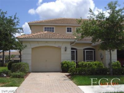 11729 Eros Road Lehigh Acres, FL 33971 - Photo 1 of 10 a front view of a house with garden