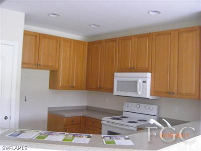 11729 Eros Road Lehigh Acres, FL 33971 - Photo 4 of 10 a kitchen with a sink cabinets and utility