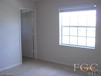 11729 Eros Road Lehigh Acres, FL 33971 - Photo 8 of 10 an empty room with windows
