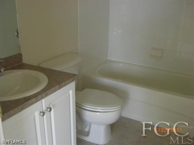 11729 Eros Road Lehigh Acres, FL 33971 - Photo 10 of 10 a bathroom with a toilet and a sink