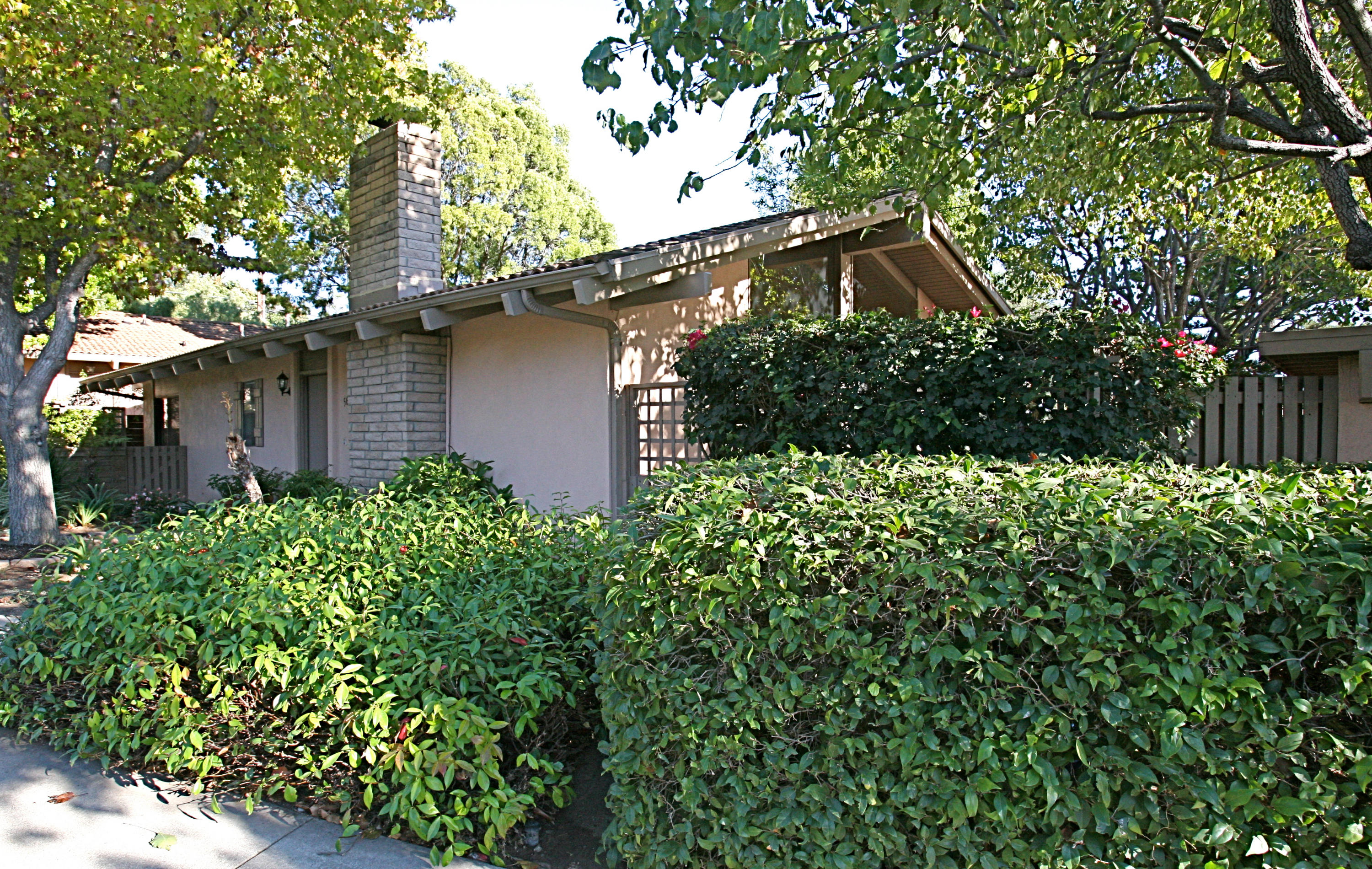 561 North La Cumbre Road Santa Barbara, CA 93110 - Photo 1 of 12 a backyard of a house with lots of green space and garden