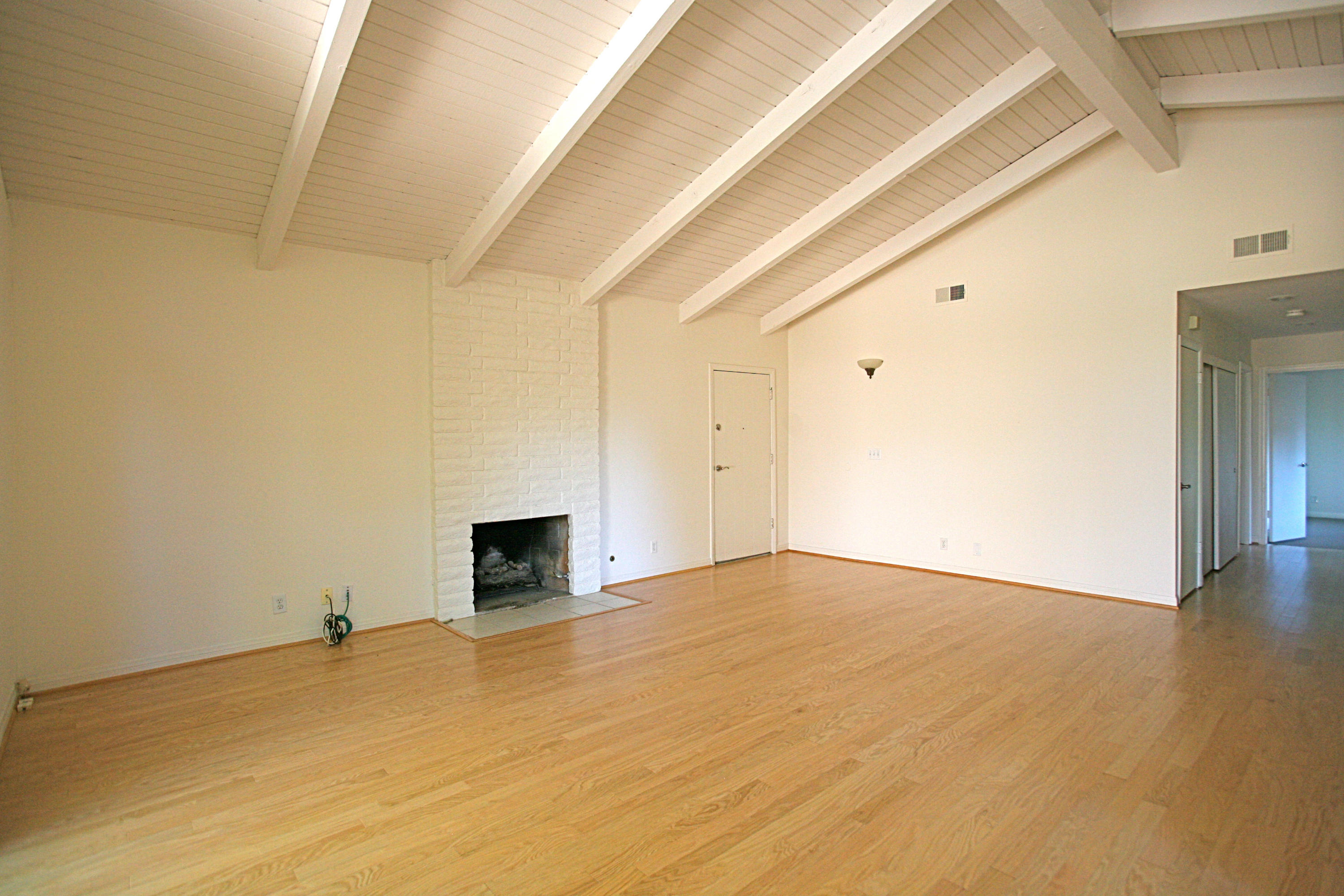 561 North La Cumbre Road Santa Barbara, CA 93110 - Photo 2 of 12 a view of empty room with wooden floor and fireplace