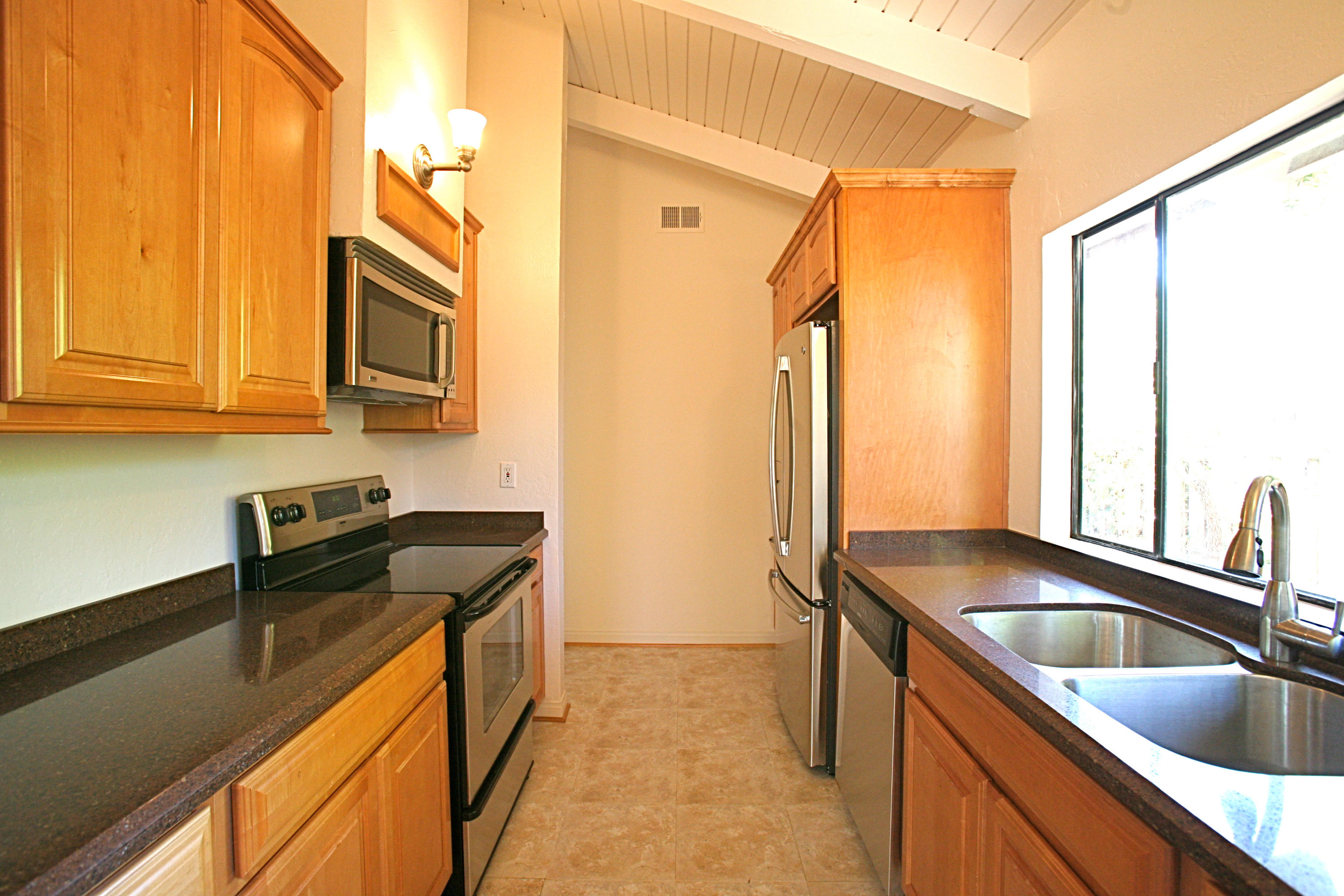 561 North La Cumbre Road Santa Barbara, CA 93110 - Photo 6 of 12 a kitchen with stainless steel appliances a sink stove and cabinets