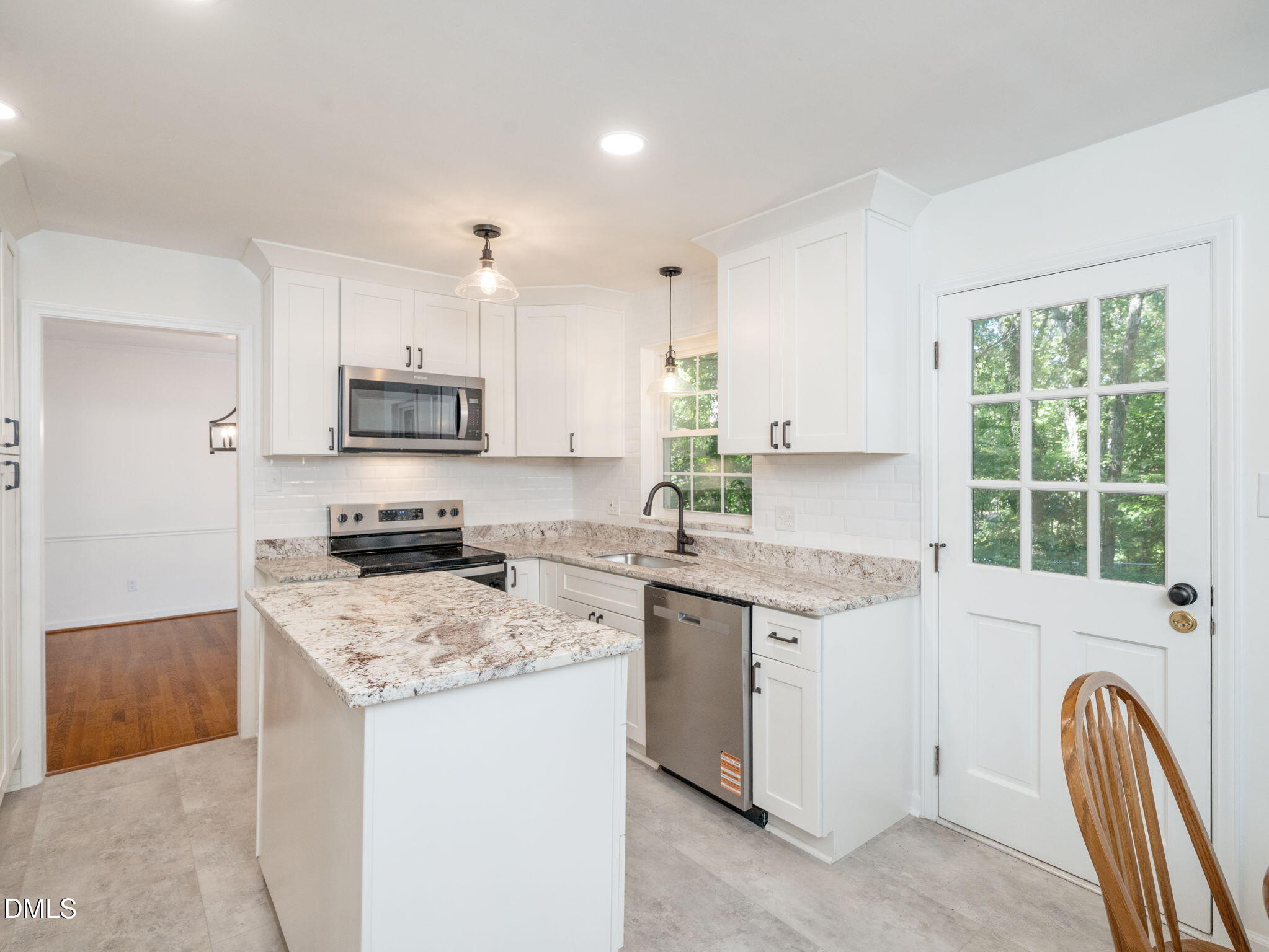 705 Villawood Court Raleigh, NC 27615 - Photo 13 of 31 This elegant kitchen features new lighting, LVT flooring, new SS appliances and a built-in cabinet pantry.