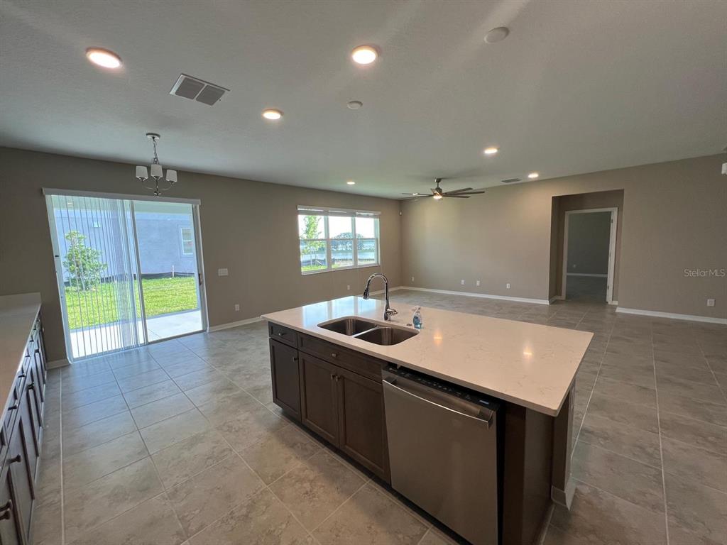 9429 Crescent Ray Drive Wesley Chapel, FL 33545 - Photo 4 of 40 a kitchen with stainless steel appliances granite countertop a sink and a stove