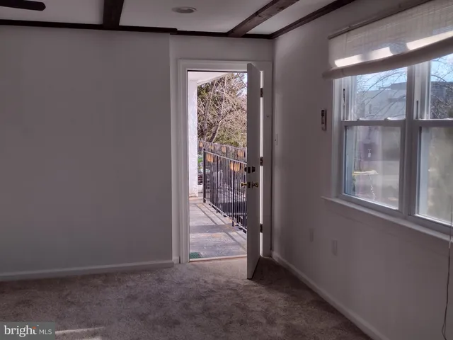 a sign that is on a brick wall with a white fence