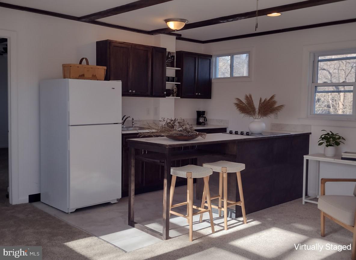 131 North Main Street New Hope, PA 18938 - Photo 4 of 26 a white kitchen with a table and a refrigerator