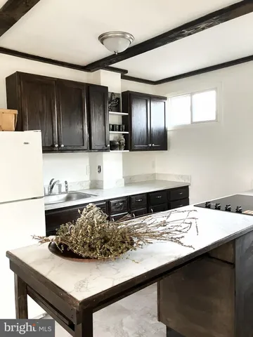 a kitchen with a sink a stove and refrigerator