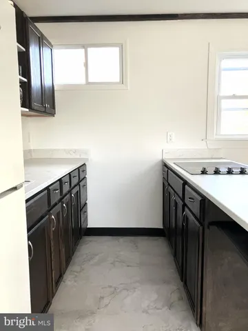 a kitchen with a sink a stove and cabinets