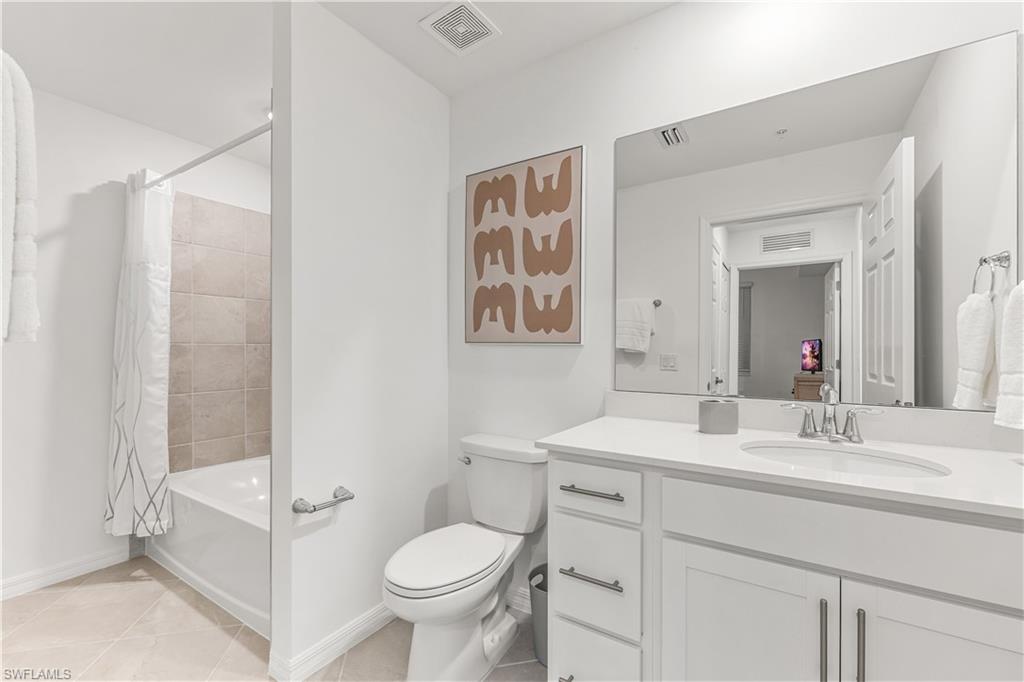 43977 Boardwalk Loop, Unit 2315 Babcock Ranch, FL 33982 - Photo 11 of 15 a bathroom with a sink toilet and shower