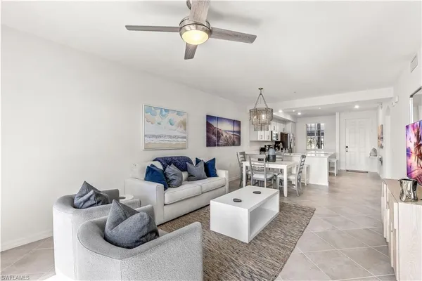 a view of a dining room with furniture and chandelier