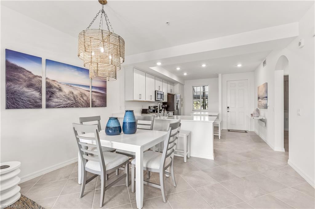 43977 Boardwalk Loop, Unit 2315 Babcock Ranch, FL 33982 - Photo 3 of 15 a view of a dining room with furniture and chandelier