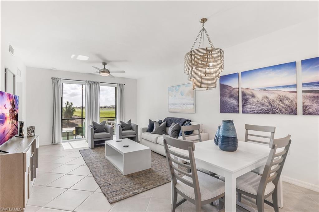43977 Boardwalk Loop, Unit 2315 Babcock Ranch, FL 33982 - Photo 4 of 15 a living room with furniture a window and a table