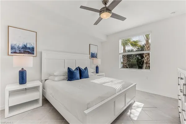 a bedroom with a bed and a lamp