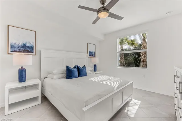 a bedroom with a bed and a lamp