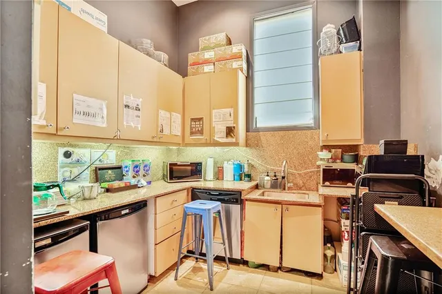 a kitchen with a sink cabinets and window