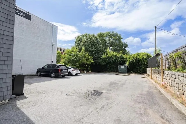 a view of backyard with parked car