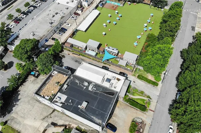 an aerial view of a pool patio deck and outdoor seating