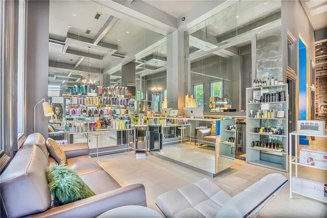 a living room with lots of chairs and a table