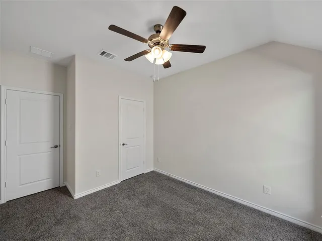 a large white kitchen with stainless steel appliances granite countertop a stove and a sink