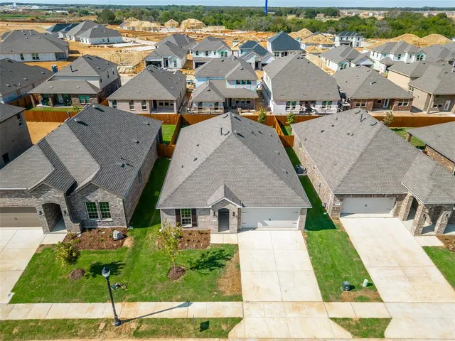 an aerial view of multiple houses with yard
