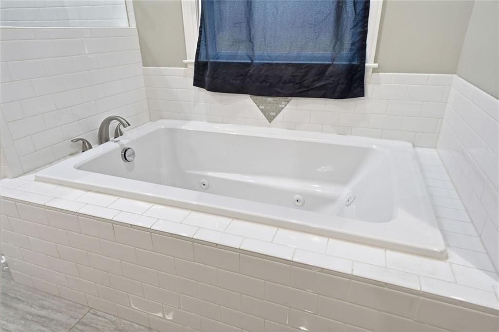 1006 Owens Store Road Canton, GA 30115 - Photo 29 of 48 a bathroom with a bathtub