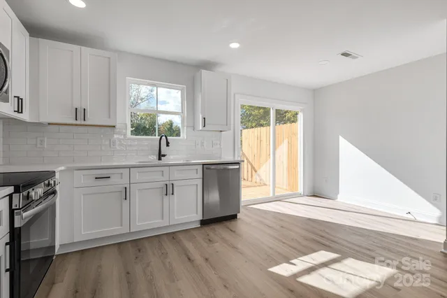 a kitchen with sink cabinets and window