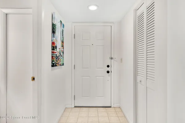 a kitchen with stainless steel appliances a refrigerator sink and white cabinets