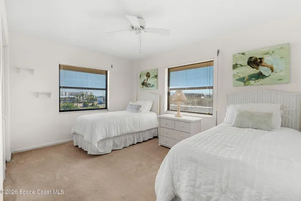 a kitchen with stainless steel appliances a refrigerator sink and white cabinets