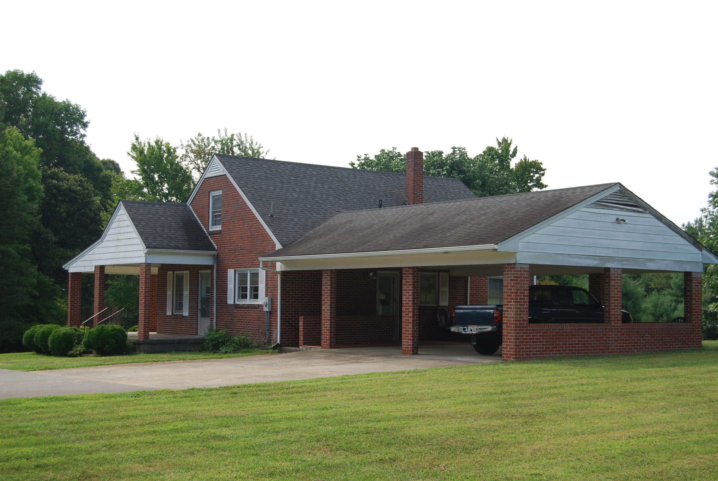 403 Morgans Fork Road Penhook, VA 24137 - Photo 2 of 5 a front view of a house with a garden