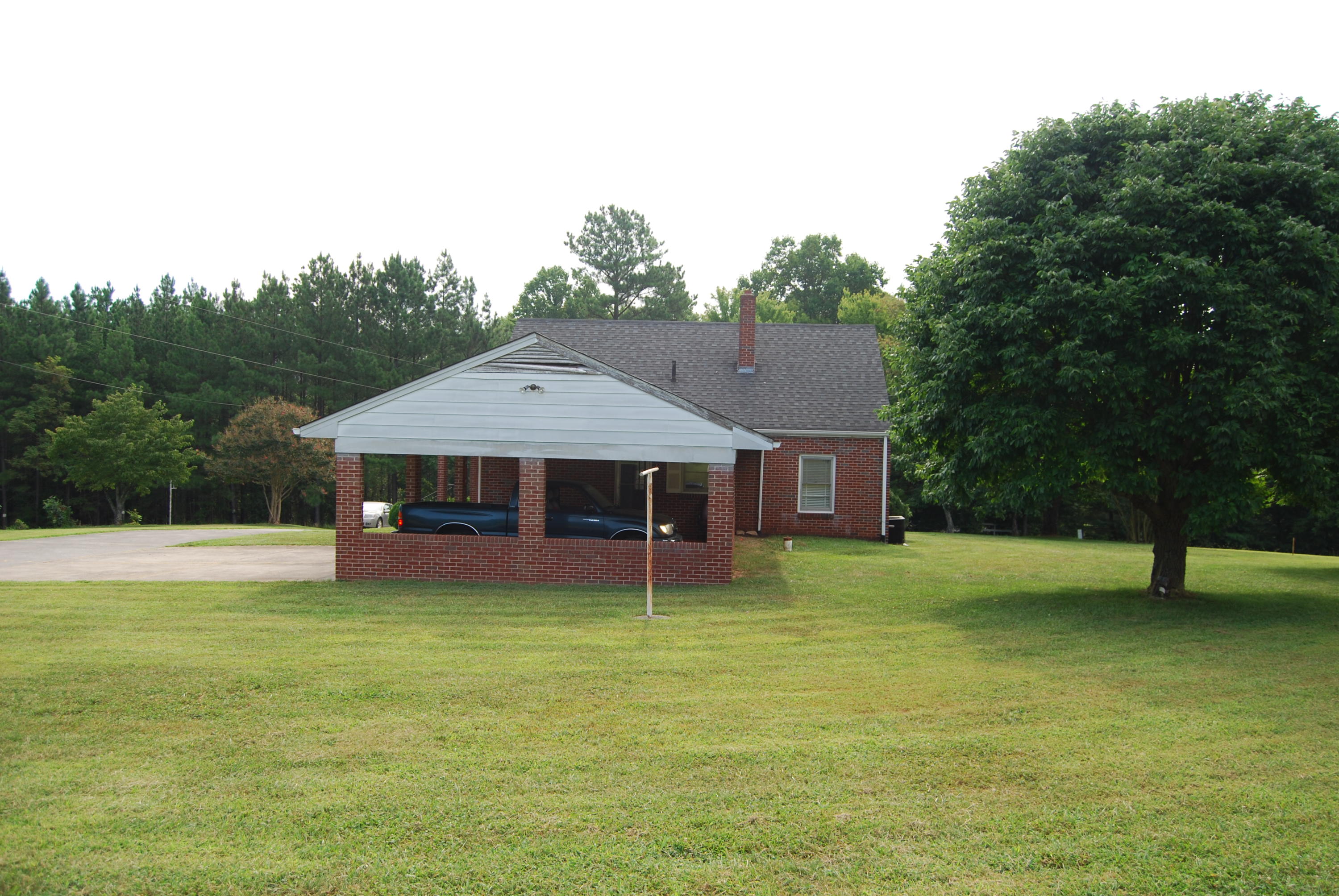 403 Morgans Fork Road Penhook, VA 24137 - Photo 4 of 5 a big house with a big yard and large trees