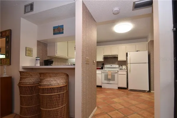 a kitchen with a stove a refrigerator and a sink