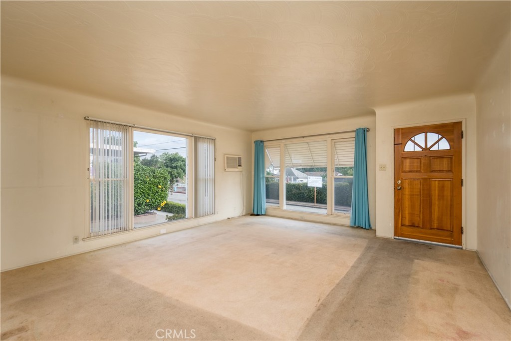 12817 Beverly Boulevard Whittier, CA 90601 - Photo 2 of 30 a view of a room with a large window and front door