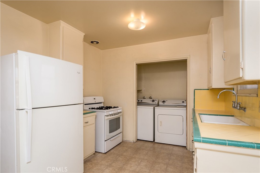 12817 Beverly Boulevard Whittier, CA 90601 - Photo 21 of 30 a kitchen with a refrigerator and a stove