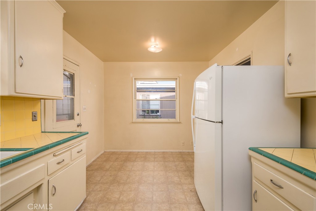 12817 Beverly Boulevard Whittier, CA 90601 - Photo 23 of 30 a kitchen with a refrigerator and a sink