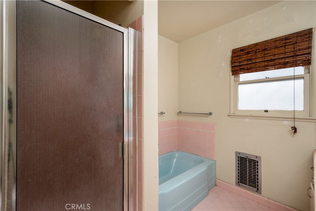 12817 Beverly Boulevard Whittier, CA 90601 - Photo 9 of 30 a bathroom with a tub and a shower