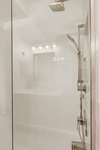 a bathroom with a bathtub and a shower