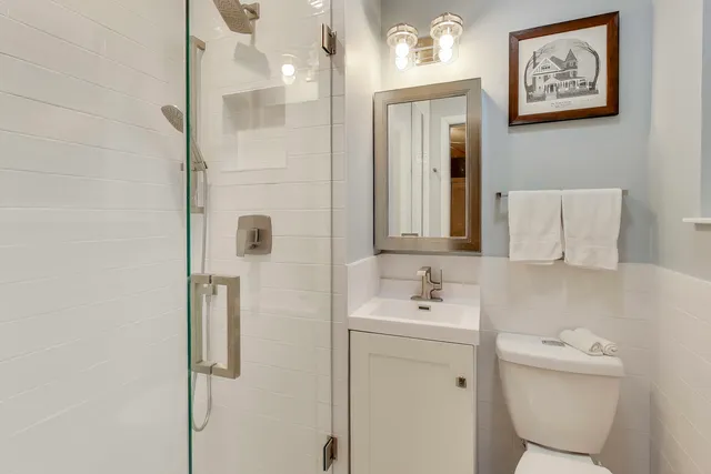 a bathroom with a toilet sink and shower