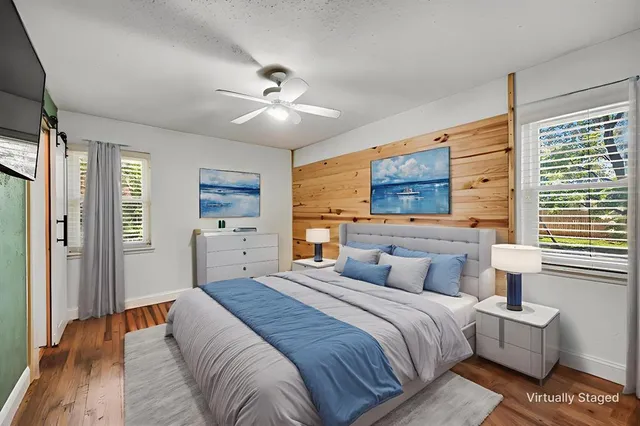 a bedroom with a large bed and a window