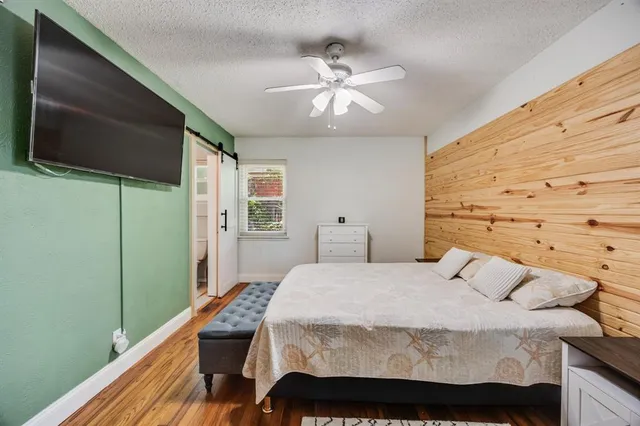 a bedroom with a bed and a flat screen tv
